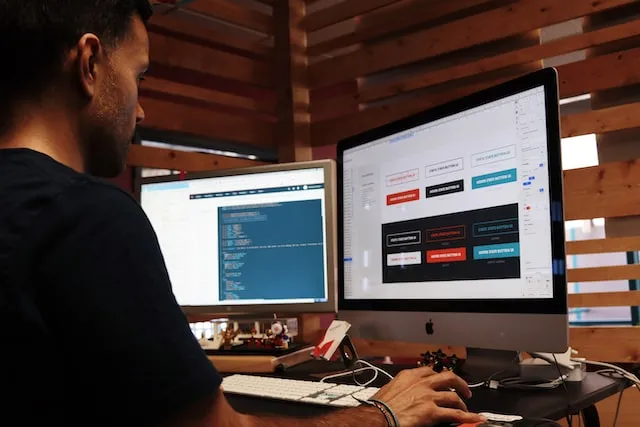 คนนั่งอยู่หน้าสองหน้าจอและพยายามสร้างหน้า Landing Page ของ Google Ad ใน WordPress