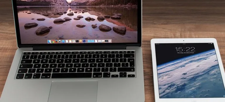 una computadora portátil, una tableta y un teléfono móvil en el escritorio
