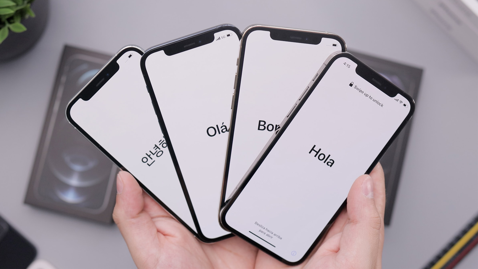 誰かの手にセットアップモードの4台のiPhone